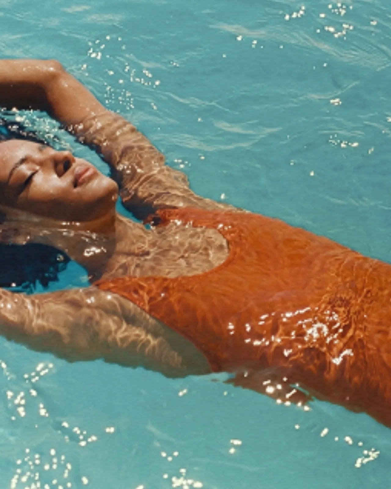 Guest floating in the pool at PLAYA DIA